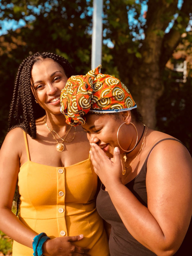 Colourful African headwrap and Box braids worn by our beautiful East African women. Here the jewellery is East African
